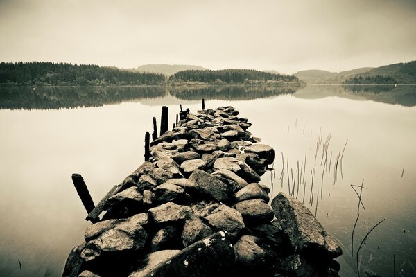 A pile of stones protrudes into the sea