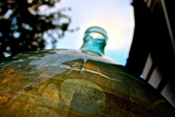 Water from a green bytulka in the rain