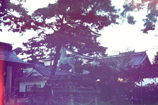 Statue of a horse on the roof of a hut