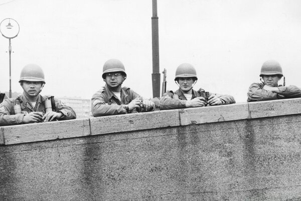 A group of soldiers at a concrete wall