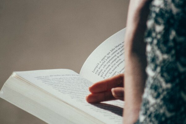 A girl reading a big book