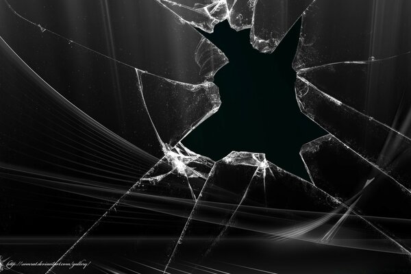 Broken glass on a black background resembles a spider web