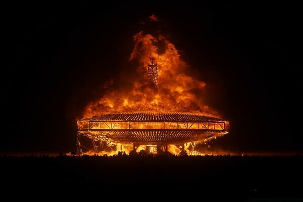 A huge building is burning at night