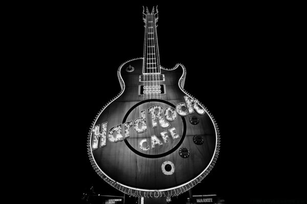 Guitar on a black background with an inscription in the middle