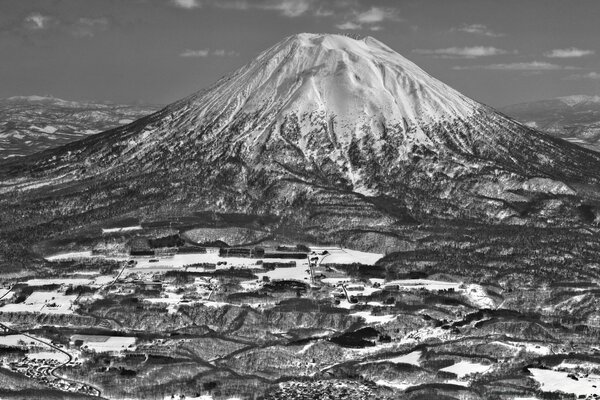 Black and white landscape of a snow-covered volcano