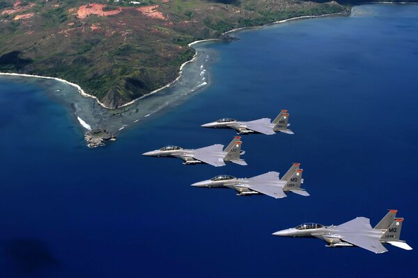 A wedge of fighters over the blue sea