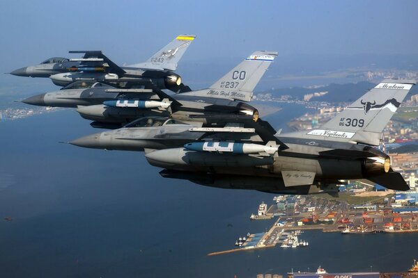 Formation of military fighters over the sea