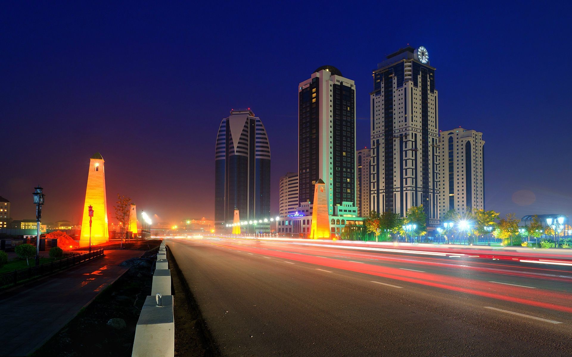 city downtown traffic highway skyscraper dusk road travel architecture street cityscape fast blur transportation system urban evening car skyline building bus