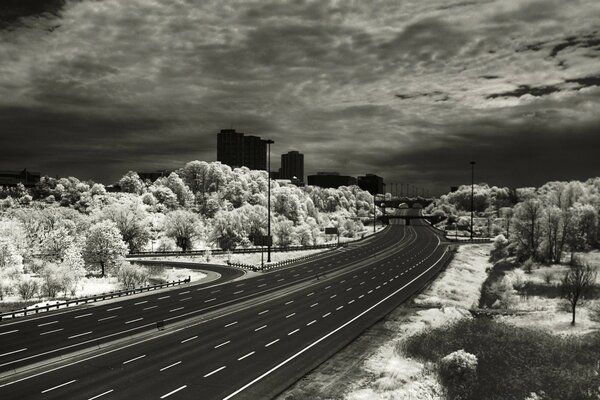 An empty road to the city. Black and white