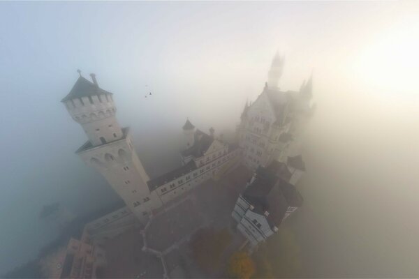 Castle in the fog around the water