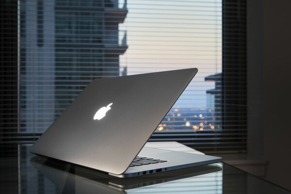 Laptop on the table near the window