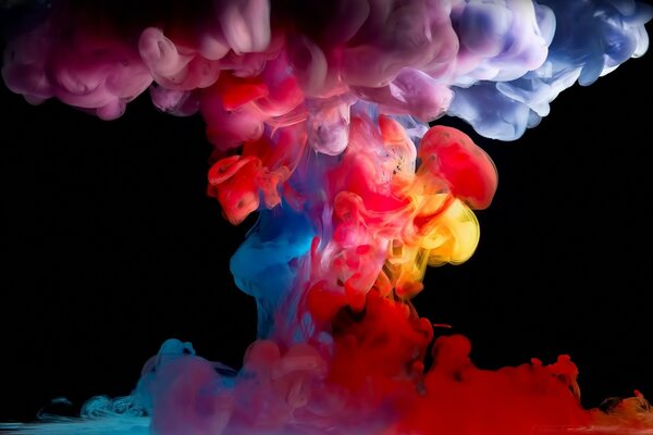 Explosion of multicolored smoke on a dark background