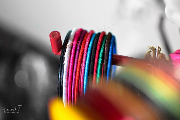 Multicolored Christmas threads on a gray background