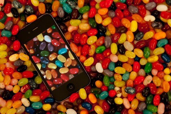 Candy in the form of dragees with a phone