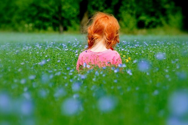 A red-haired girl in nature. Children