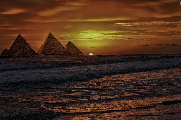 Dawn in the sea against the background of the pyramids