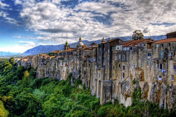 A city in the form of a wall with a green forest