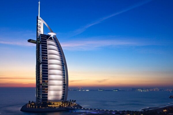 Architecture of the building against the background of the sea and sunset