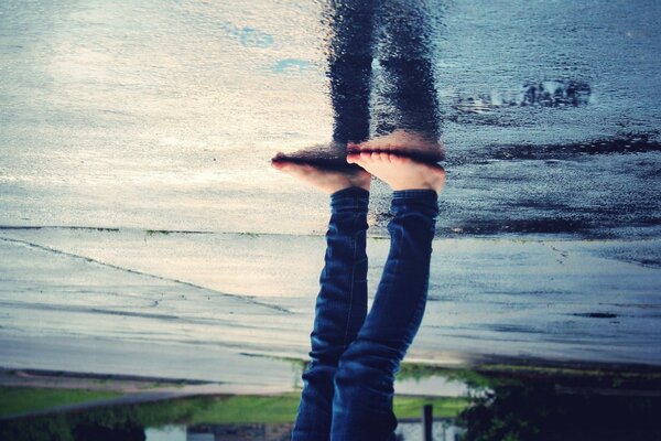 Reflection of a man on a wet road