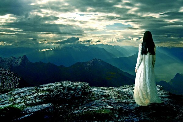 A girl at sunset in the mountains