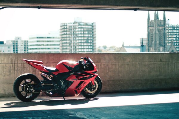 Red sports motorcycle on the background of the city