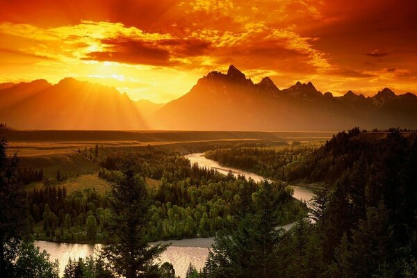 Sunset on the background of mountains and river