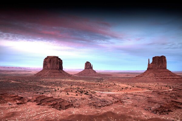 Sand boulders and rocks against the sky