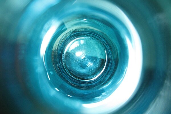 Circles on the water. Graphic design. Photo of a glass jar inside