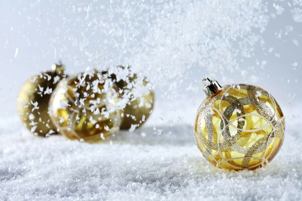 Golden Christmas balls in the snow