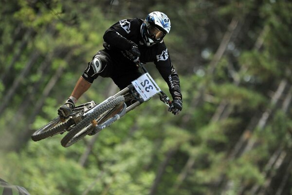 A cyclist does a trick in the air