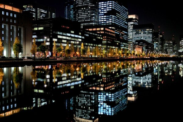 Reflection of the night city in the river
