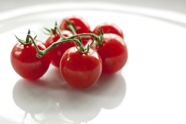 Delicious cherry tomatoes on a white platter