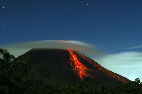 Burning volcano on the background of the lunar sky