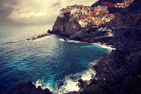 Houses on a cliff by the blue sea