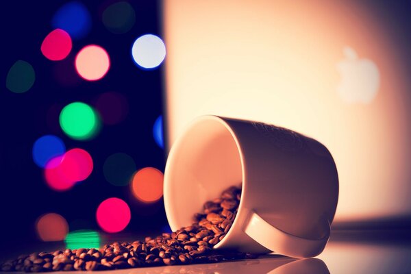 Coffee beans scattered from a mug