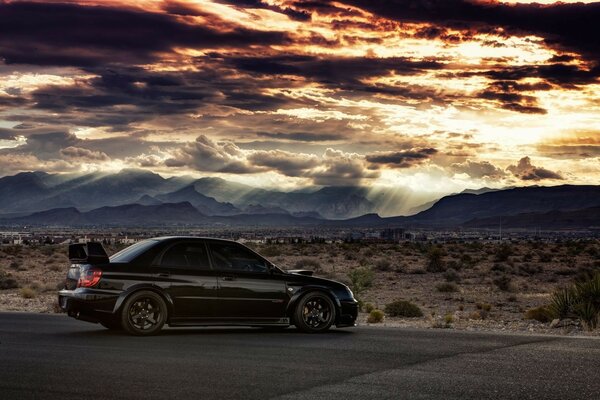 Car on the background of the desert and mountains