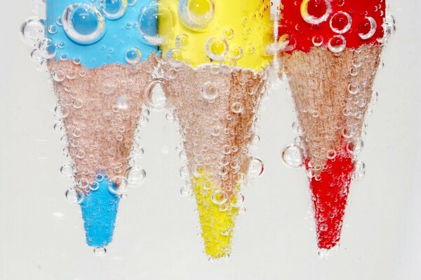 Three pencils dipped in water