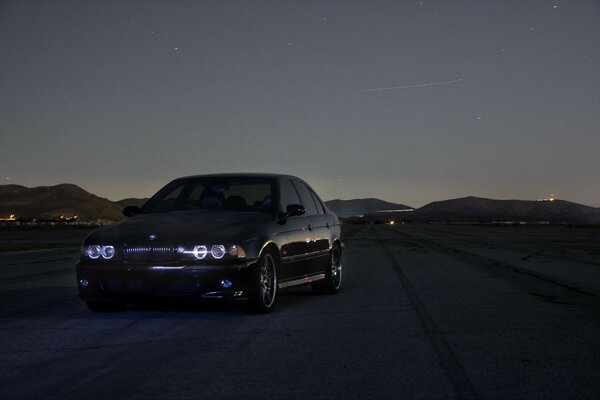 A black car on the road in the evening