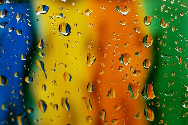 Abstraction. Raindrops on a rainbow background