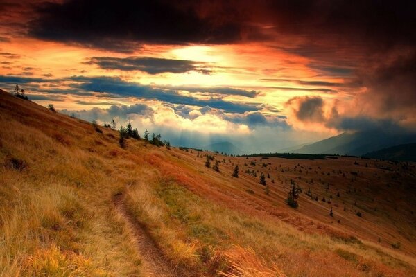 Crimson sunset in a hilly area