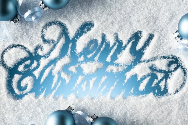 Merry christmas inscription on snow and blue balloons