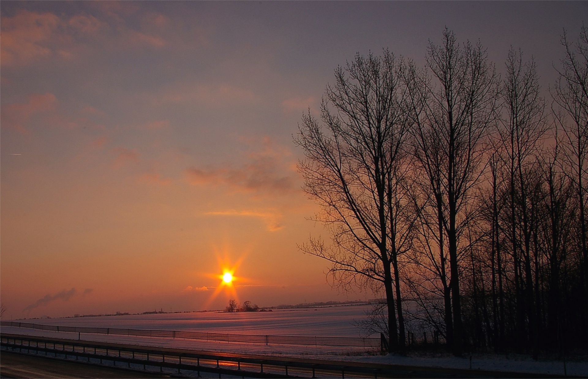 the sunset and sunrise sunset dawn evening sun landscape dusk fog water sky light nature winter mist fair weather lake outdoors tree