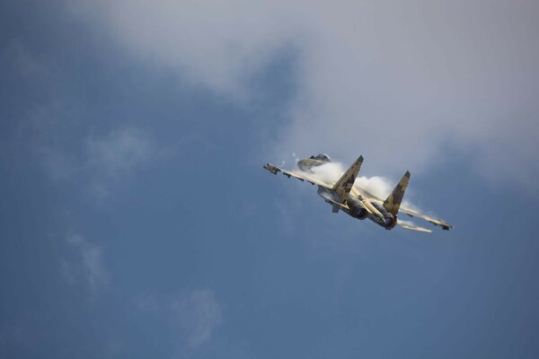 Military-colored aircraft in the sky