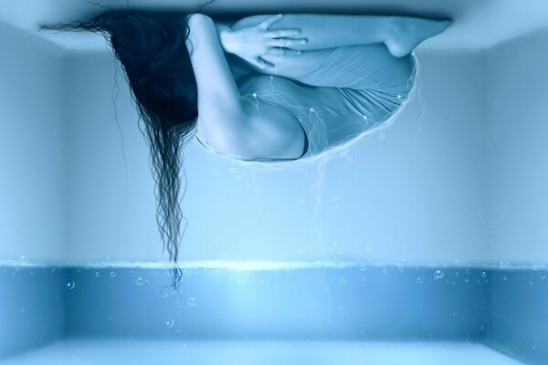 Wet woman on the background of water in the room