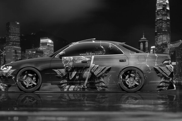 Gray car with graffiti in the city