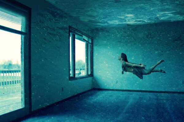 A girl is floating in a room filled with water