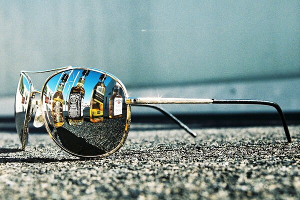 Glasses lying on the asphalt or on the beach