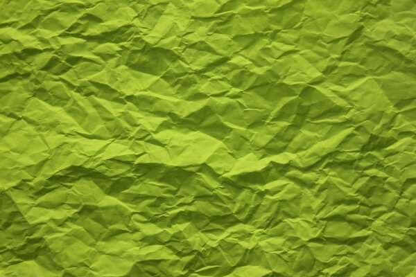 Green crumpled texture on paper