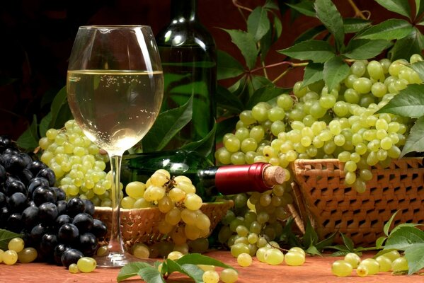 Wine bottle basket glass leaves white grapes