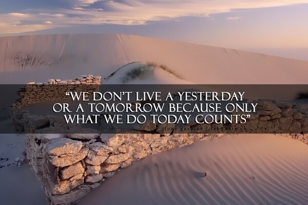 A large amount of sand with stone walls and an inscription